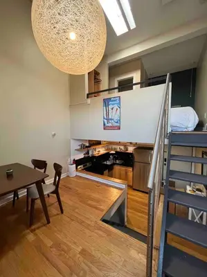 a room with a table and a room with a staircase at Affordable & Chic RiNo/LoDo/Dtown Loft- Walkable in Denver