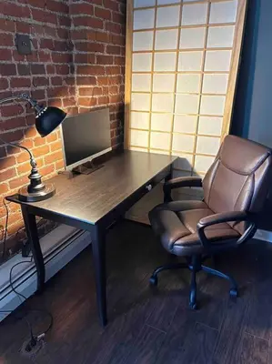 a desk with a computer monitor and a chair at Affordable & Chic RiNo/LoDo/Dtown Loft- Walkable in Denver