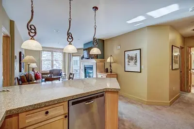 a kitchen with a counter and a living room at 8179 Silver Mill condo in Keystone