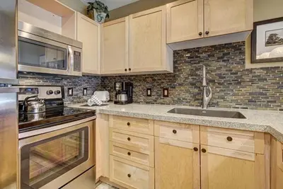 a kitchen with a sink and a stove top oven at 8179 Silver Mill condo in Keystone