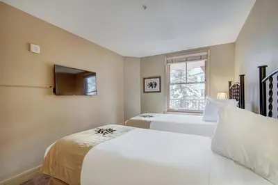 a bedroom with two beds and a window at 8179 Silver Mill condo in Keystone
