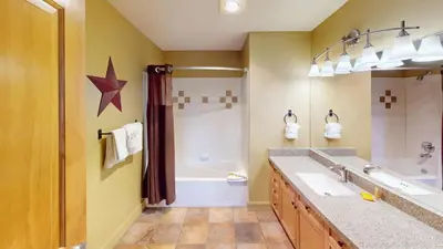 a bathroom with two sinks and a tub and a shower at 8179 Silver Mill condo in Keystone