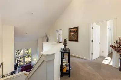 a living room with a staircase and a white ceiling at 1849 The Seasons townhouse in Keystone