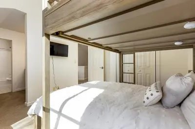 a bedroom with a large white bed with white pillows at 1849 The Seasons townhouse in Keystone