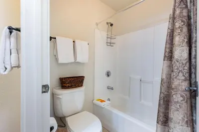 a bathroom with a toilet and a tub and a shower at 1849 The Seasons townhouse in Keystone