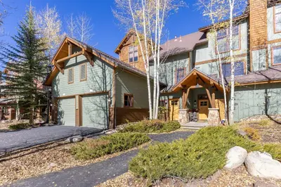 an exterior view of a house with a garage at 1849 The Seasons townhouse in Keystone