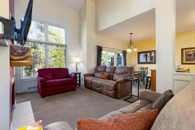 a living room with a couch and a chair at 1849 The Seasons townhouse in Keystone