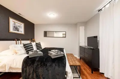 a bedroom with a bed and a television in it at Adorable 2-Bedroom Modern Basement in Denver