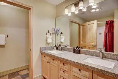 a bathroom with two sinks and a large mirror at 8231 Silver Mill condo in Keystone