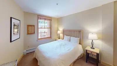a bedroom with a white bed and a window at 8231 Silver Mill condo in Keystone
