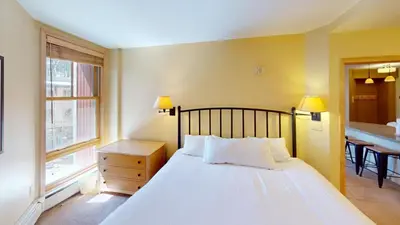 a bedroom with a large white bed and a window at 8231 Silver Mill condo in Keystone