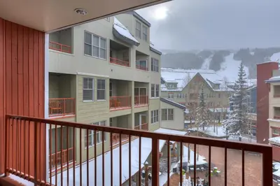 a balcony of a building with snow on the ground at 8231 Silver Mill condo in Keystone