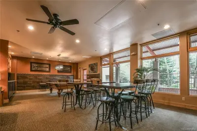 a dining room with a ceiling fan and tables and chairs at 8231 Silver Mill condo in Keystone