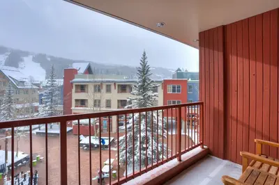 a balcony with a view of a snow covered yard at 8231 Silver Mill condo in Keystone