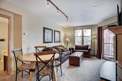 a living room with a table and a couch at 8231 Silver Mill condo in Keystone