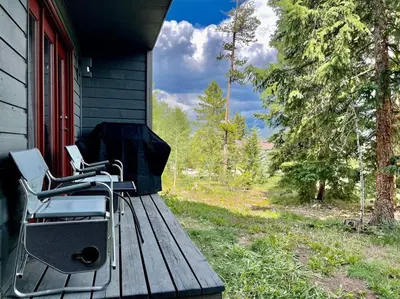 a chair sitting on the porch of a house at Cozy Ski Condo + Hot Tub + Fireplace + Heated Pool in Silverthorne