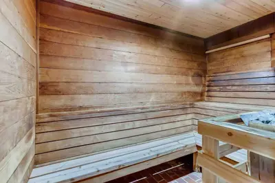 a sauna with wooden walls and a sink at Cozy Ski Condo + Hot Tub + Fireplace + Heated Pool in Silverthorne