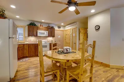 a kitchen with a table and a ceiling fan at half Mi to Granby Ranch Townhome with Fireplace! in Granby