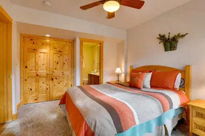 a bedroom with a bed and a ceiling fan at half Mi to Granby Ranch Townhome with Fireplace! in Granby