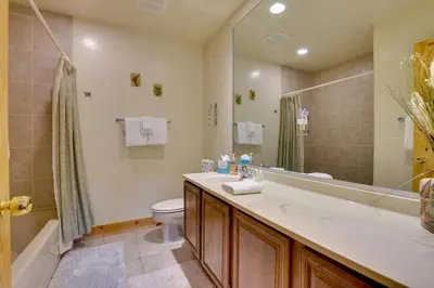a bathroom with a sink and a toilet and a shower at half Mi to Granby Ranch Townhome with Fireplace! in Granby