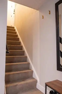 a staircase in a house with a stair case at Rocky Mountain Haven-Modern 2BD, 1BA Basement Retreat in Lakewood in Lakewood