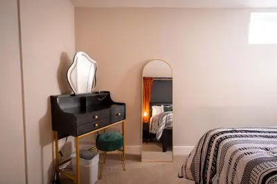 a bedroom with a dresser and a mirror and a bed at Rocky Mountain Haven-Modern 2BD, 1BA Basement Retreat in Lakewood in Lakewood