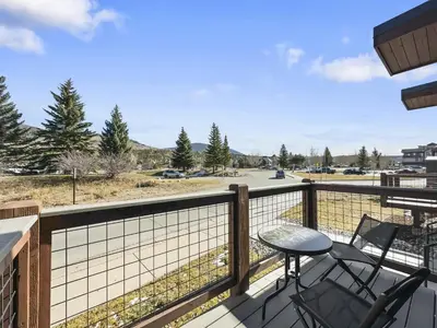 a balcony with a table and chairs and a view of a parking lot at 541 Center Circle 3Br 3,5Ba townhouse in Silverthorne