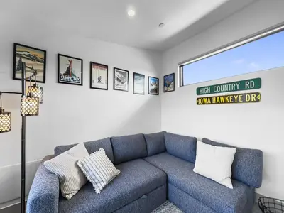 a living room with a blue couch and pictures on the wall at 541 Center Circle 3Br 3,5Ba townhouse in Silverthorne