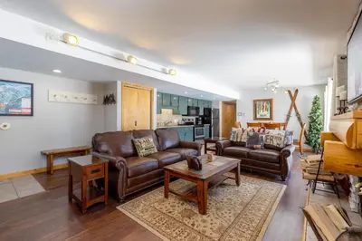 a living room with two leather chairs and a table at 1076 Wild Irishman condo in Keystone