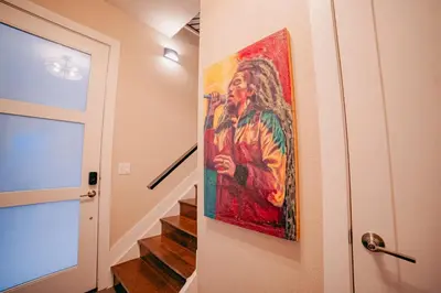 a painting of a man hanging on a wall next to a staircase at Golden Triangle Townhome at Downtown Denver in Denver