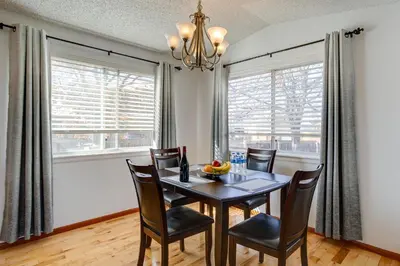 a dining room with a table and chairs and windows at Patio, Grill, Yard Pet-Friendly Denver Home! in Aurora