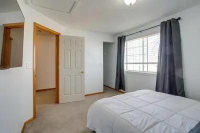 a bedroom with a white bed and a window at Patio, Grill, Yard Pet-Friendly Denver Home! in Aurora
