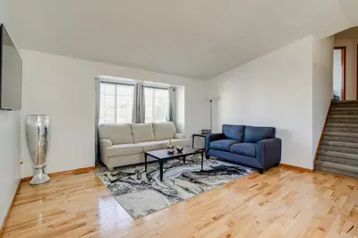 a living room with a blue chair and a couch at Patio, Grill, Yard Pet-Friendly Denver Home! in Aurora
