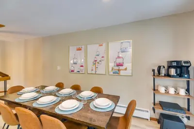 a dining room with a wooden table and chairs at Winter Park Townhome with Hot Tub, Half Mi to Dtwn! in Winter Park