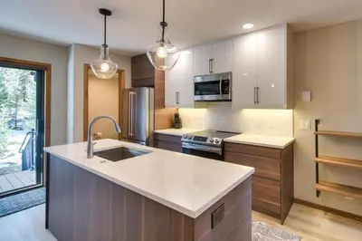 a kitchen with a sink and a counter top at Winter Park Townhome with Hot Tub, Half Mi to Dtwn! in Winter Park