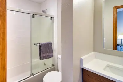 a bathroom with a toilet and a sink and a shower at Winter Park Townhome with Hot Tub, Half Mi to Dtwn! in Winter Park