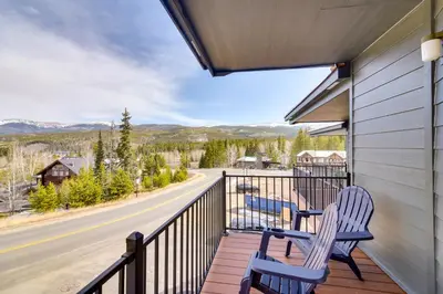 two chairs on a balcony with a view of a road at Winter Park Townhome with Hot Tub, Half Mi to Dtwn! in Winter Park