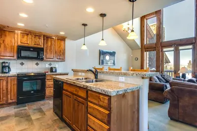 a kitchen with a sink and a living room at Spacious Fraser Gem 7 Mi to Winter Park! in Fraser