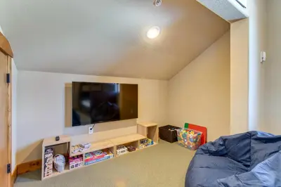 a living room with a flat screen tv on the wall at Spacious Fraser Gem 7 Mi to Winter Park! in Fraser