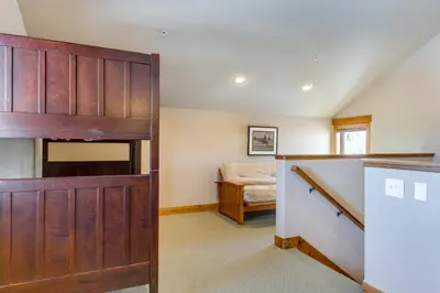 a room with a sliding barn door and a bedroom at Spacious Fraser Gem 7 Mi to Winter Park! in Fraser
