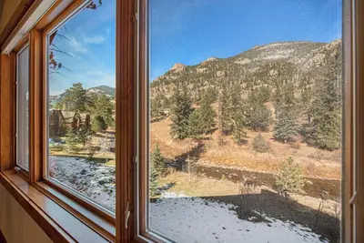 a window with a view of a mountain at Fall River Retreat - Monthly Long-Term Vacation Rental townhouse in Estes Park