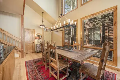 a dining room with a wooden table and chairs at Fall River Retreat - Monthly Long-Term Vacation Rental townhouse in Estes Park