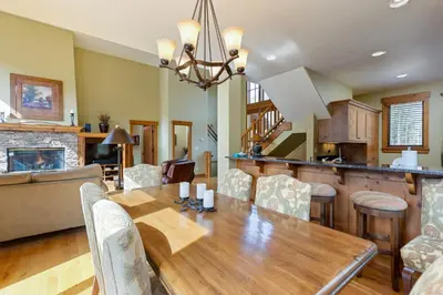 a dining room and living room with a wooden table at 66 Thackwell Lane townhouse in Keystone
