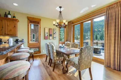a dining room with a wooden table and chairs at 66 Thackwell Lane townhouse in Keystone