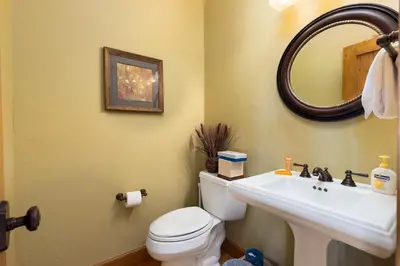 a bathroom with a white toilet and a sink at 66 Thackwell Lane townhouse in Keystone