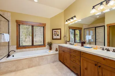a bathroom with two sinks and a bath tub and a tub at 66 Thackwell Lane townhouse in Keystone
