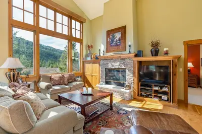 a living room with a fireplace and a tv at 66 Thackwell Lane townhouse in Keystone
