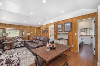 a living room with a couch and a table at Niwot Cabin - Stay in Rocky Mountain National Park - Estes Park - NEW LISTING - 22-ZONE3298 cabin in Estes Park