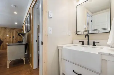 a white bathroom with a sink and a mirror at Niwot Cabin - Stay in Rocky Mountain National Park - Estes Park - NEW LISTING - 22-ZONE3298 cabin in Estes Park