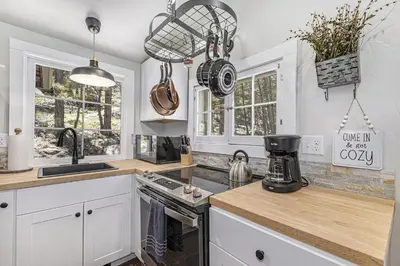 a kitchen with white cabinets and a counter top at Niwot Cabin - Stay in Rocky Mountain National Park - Estes Park - NEW LISTING - 22-ZONE3298 cabin in Estes Park